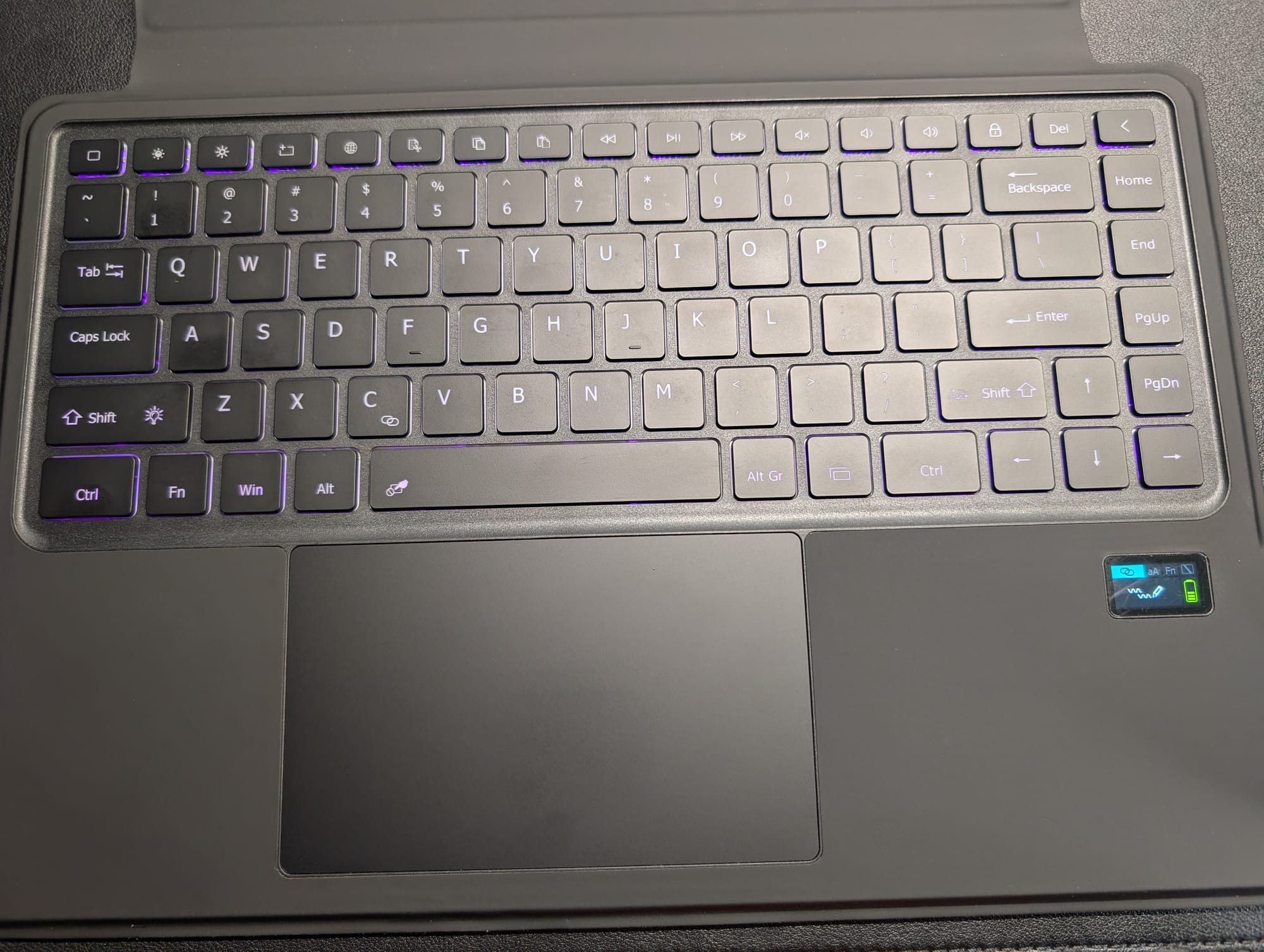 The Sahara keyboard is shown with its purple backlight and screen on
