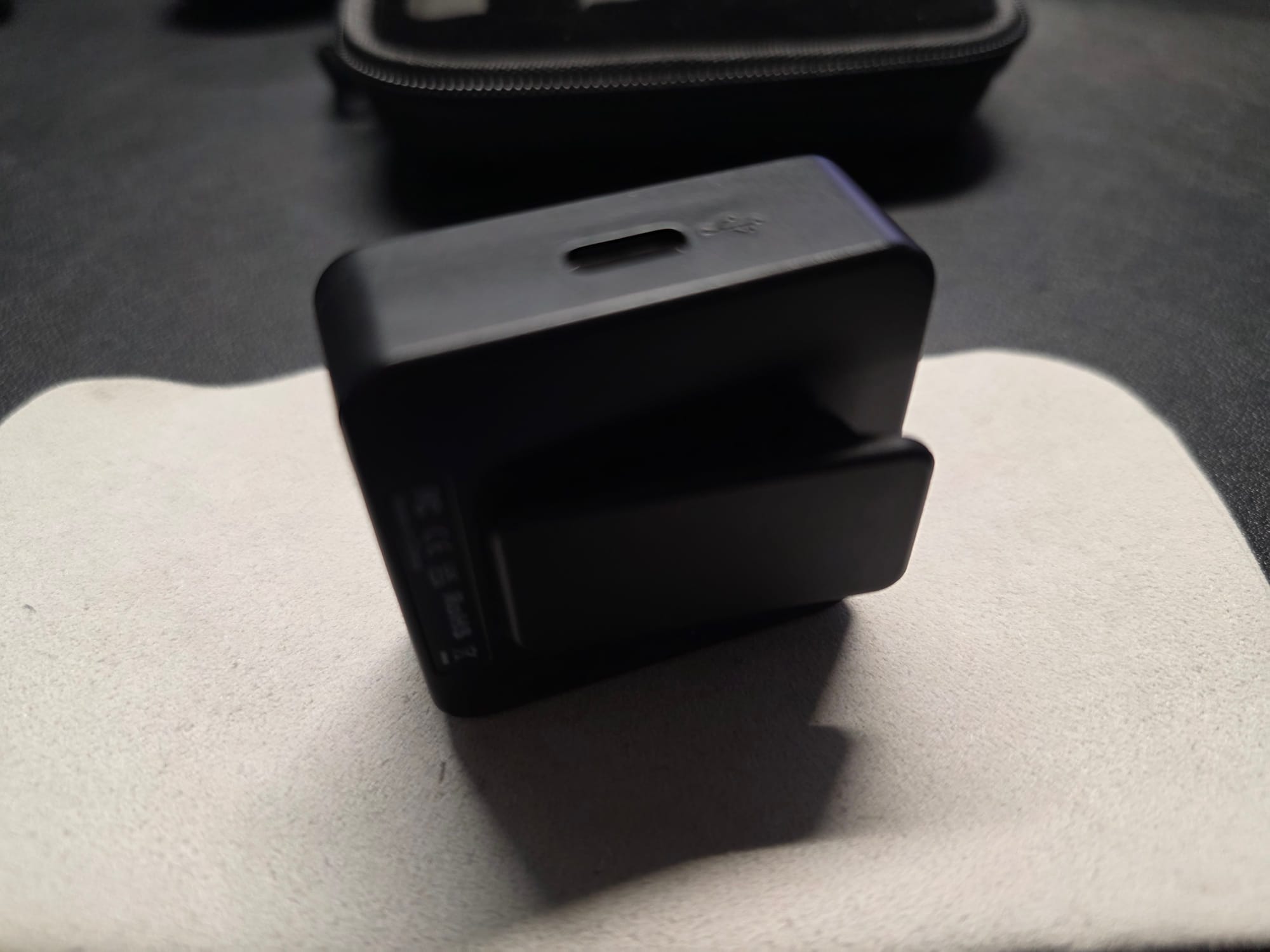 The Accessport Pro with USB C port displayed. It is standing on its side on top of a white microfiber cloth on a black desk.