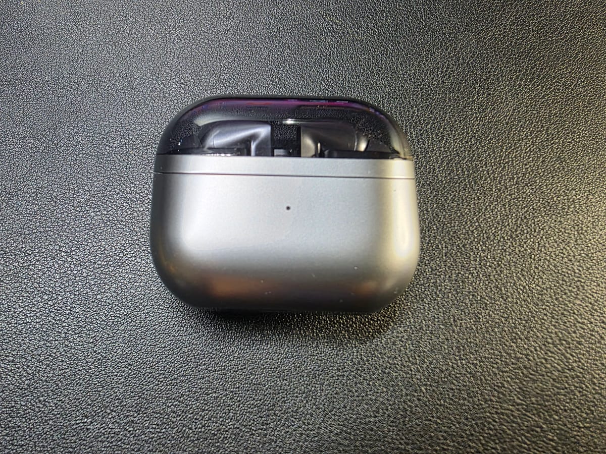Samsung Galaxy Buds3 Pro, inside their closed case on a black background