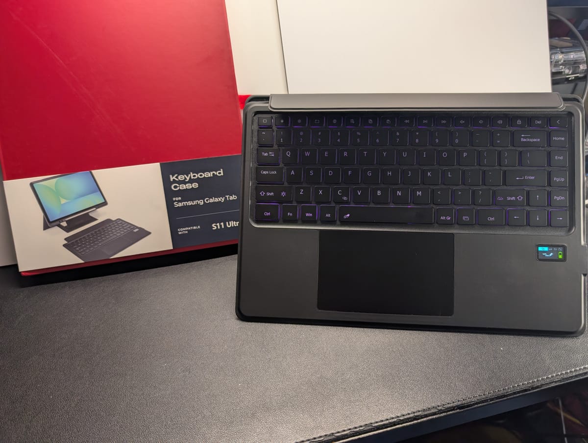 The keyboard portion of the case is pictured to the right of the product box, which is red with a label on it showing the 2 pieces of the case