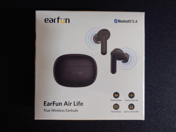Photo of the box the earbuds come in, listing features such as 4 mics for calls, powerful bass, and audio app