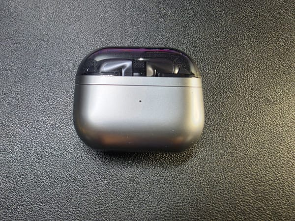 Samsung Galaxy Buds3 Pro, inside their closed case on a black background
