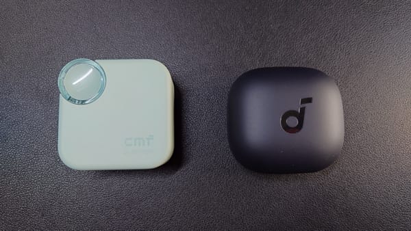 CMF Buds 2 by Nothing in green on left.  The case has a dial in the upper left-hand corner.  Soundcore P40i by Anker in black on the right.  The case is plain except for a logo on the top.